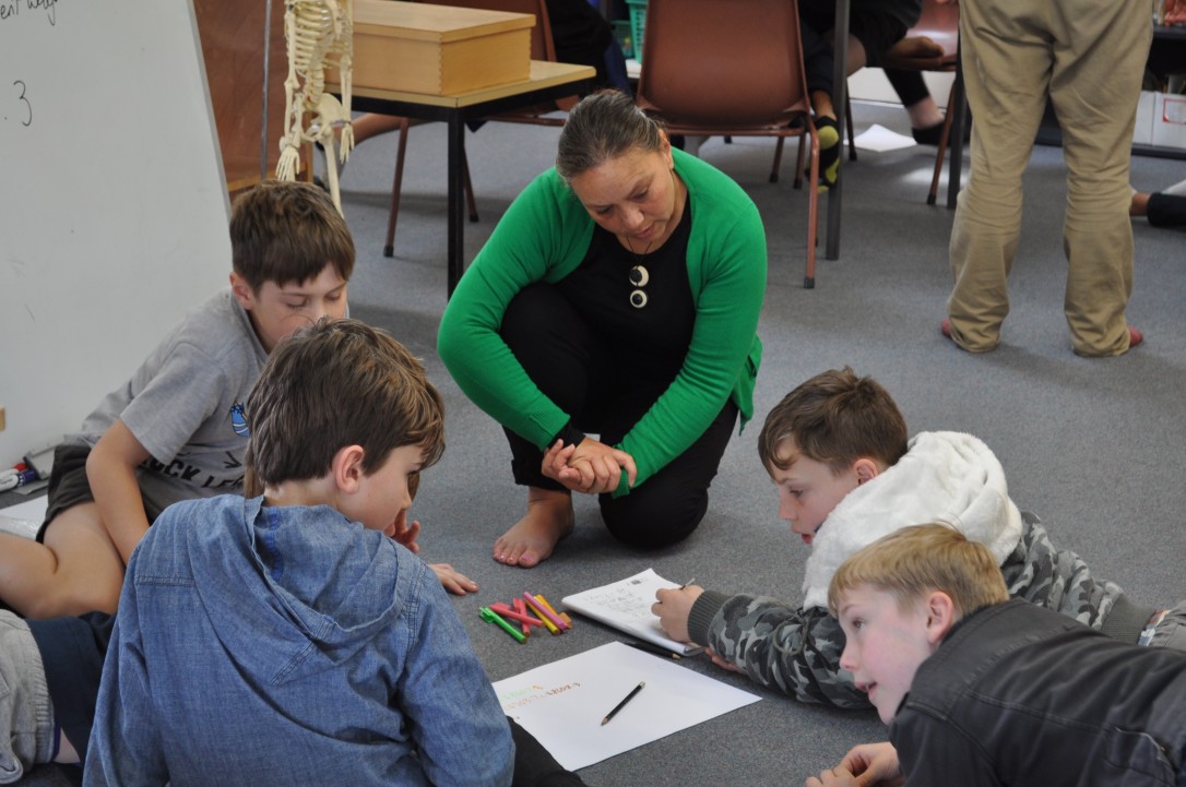 A teacher aide facilitates a mixed-ability student group