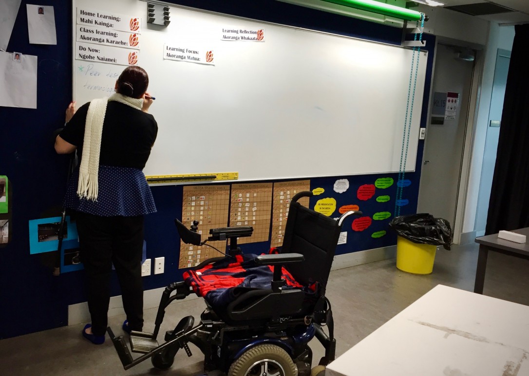 Teacher displaying daily timetable on the whiteboard