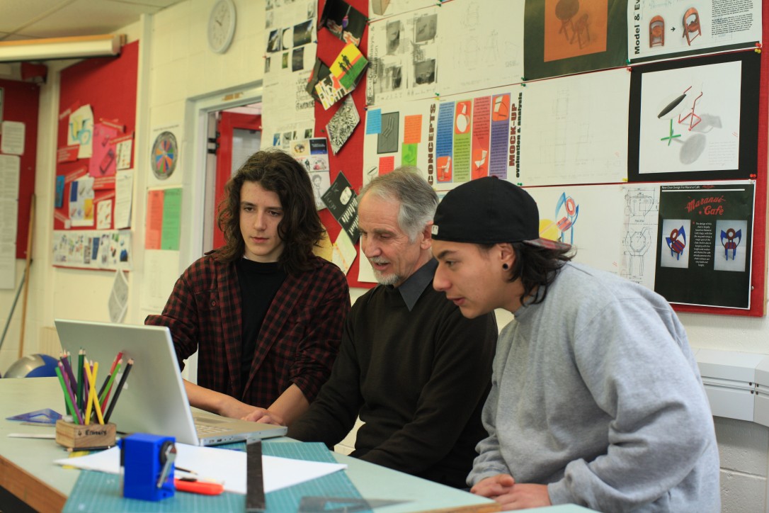 Students working with their teacher
