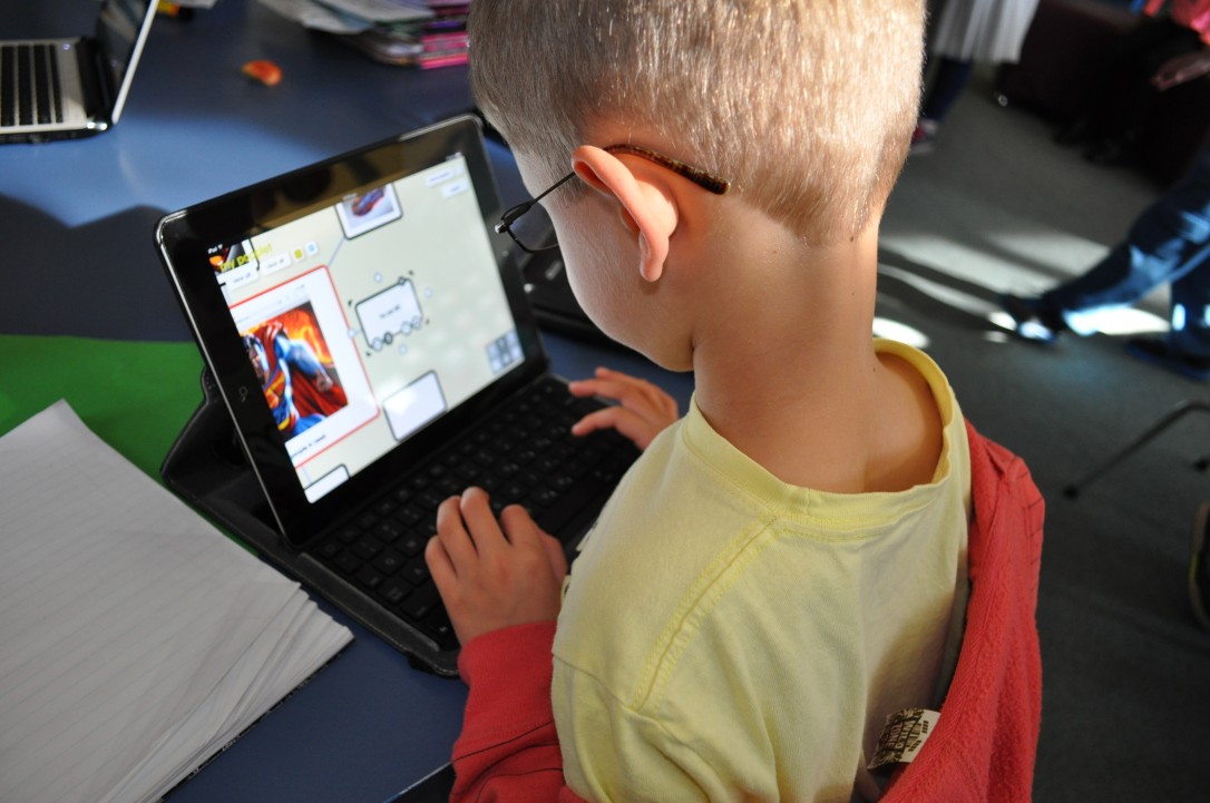Student creating a popplet on an ipad