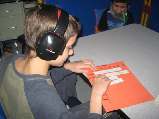 Student using headphones to remove noise distractions