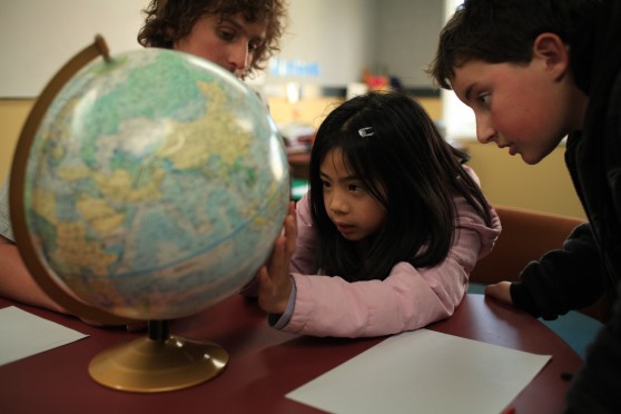 Students looking at a globe